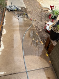 Sidewalk being pressure washed