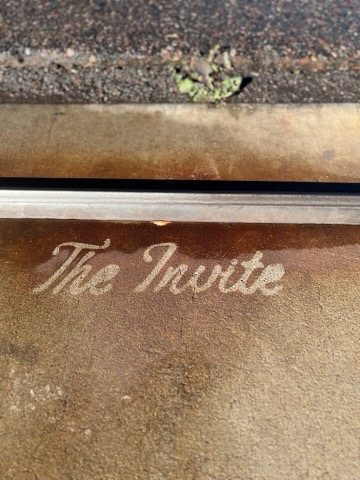 The Invite clean tag pressure-washed on concrete